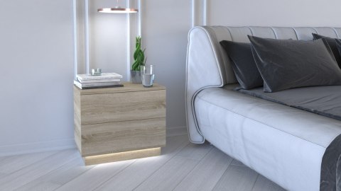 Szafka nocna led podświetlana dąb sonoma SN-306-SON+LED w aranżacji sypialni – widok w półprofilu z dekoracjami na blacie.